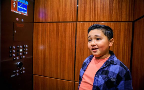 Boy stands in elevator